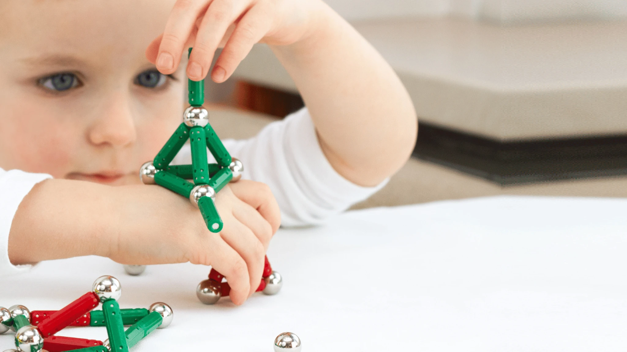 A child playing with magnetic construction toys