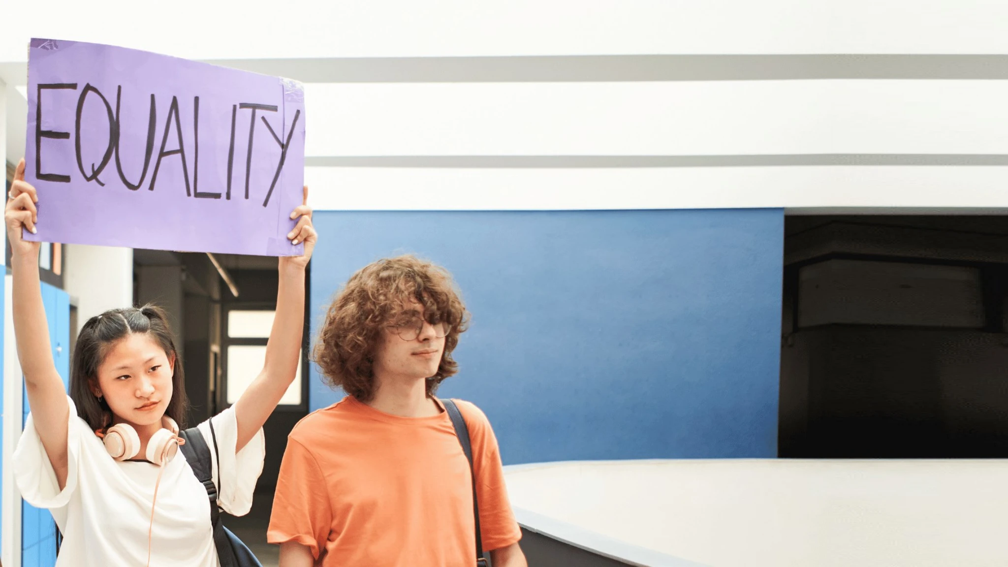 Children holding up a handmade sign reading equality
