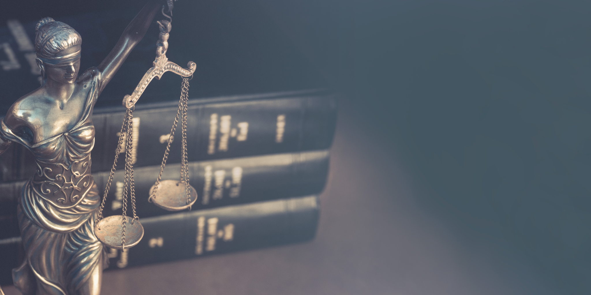 A set of scales of justice beside law books