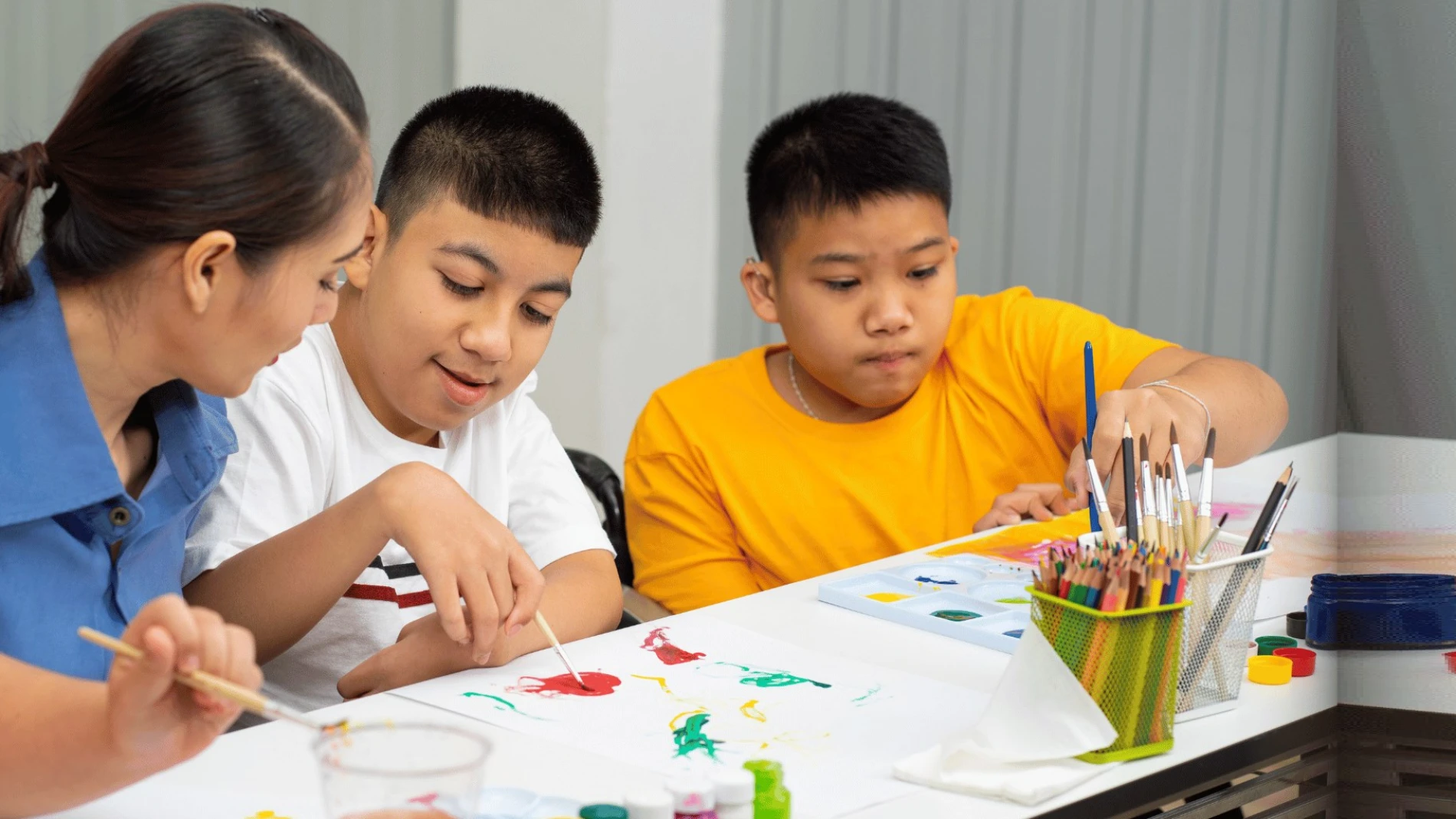 Children doing craft activities together at a table